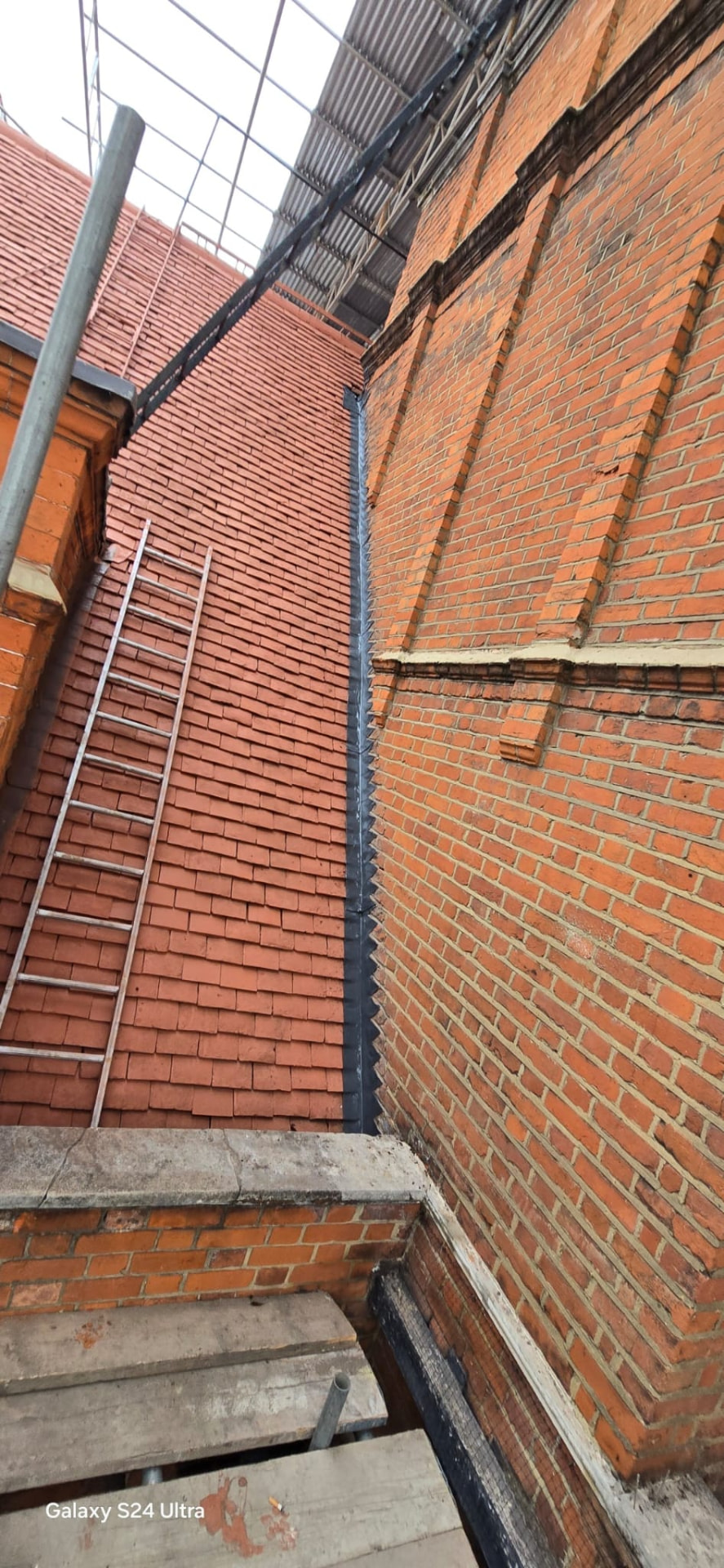 Tiled slope meeting the original elevation with new leadwork running the full height